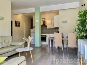Apartment Monica has a light living room with dinning table and open kitchen.
