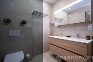 Second bathroom in pool Villa Annamar has a double sink, toilet and rain shower