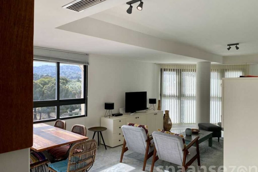Fully equipped kitchen with a view through to the living room