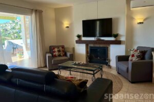 Casa Maia in Moraira has a living room with tv and fire place in Moraira