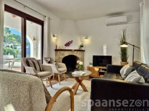 Holiday home Luciana has a light living room with sliding door to the balcony