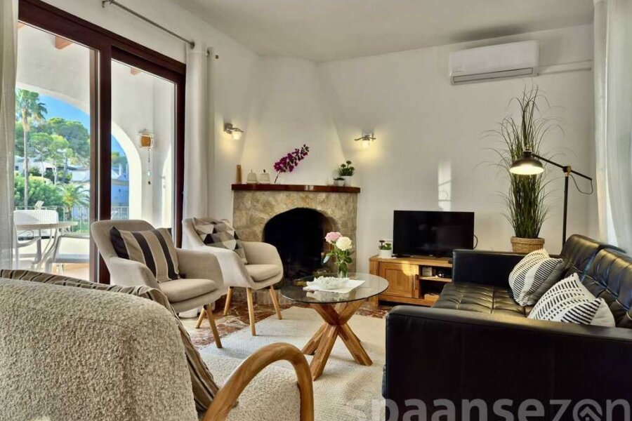 Holiday home Luciana has a light living room with sliding door to the balcony