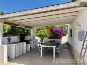 Luxury holiday villa in Moraira with a large BBQ area with a spacious dining table.