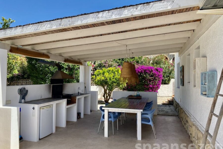 Luxury holiday villa in Moraira with a large BBQ area with a spacious dining table.