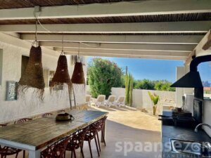 Luxury holiday villa in Moraira with a large BBQ area with a spacious dining table.