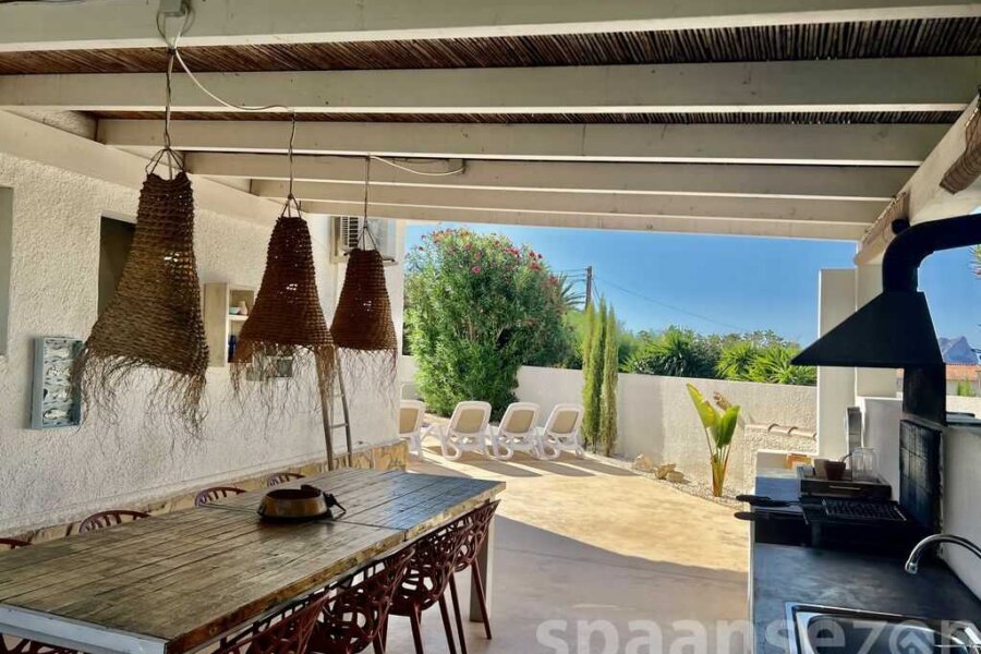 Luxury holiday villa in Moraira with a large BBQ area with a spacious dining table.