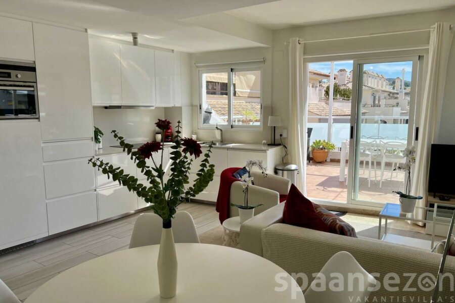 Penthouse Moraira has a dining table by the open kitchen